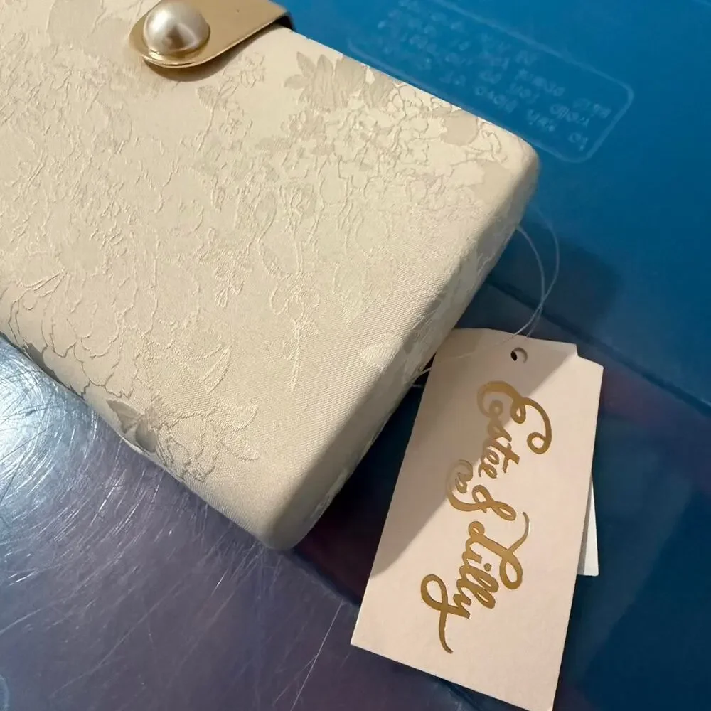 Estee & Lilly cream and white floral clutch bag with gold and pearl accents